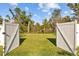 Open backyard space with a white fence, leading to a lush and private outdoor area at 7112 46Th E Ct, Ellenton, FL 34222