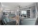 Large living room with access to the kitchen, comfortable furniture, and a TV entertainment center at 7112 46Th E Ct, Ellenton, FL 34222