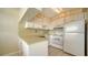 Functional kitchen with white cabinetry, tile flooring, and essential appliances for easy meal preparation at 7231 W Country Club N Dr # 231, Sarasota, FL 34243