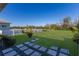 Expansive backyard with lush lawn, decorative pavers, and a serene pond view, great for outdoor enjoyment at 7742 Ridgelake Cir, Bradenton, FL 34203