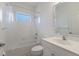 Bright bathroom featuring a tub-shower with a window and a vanity with decorative mirror trim at 7742 Ridgelake Cir, Bradenton, FL 34203