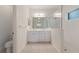 Bright bathroom with double sink vanity, framed mirror, and glass-enclosed shower at 7742 Ridgelake Cir, Bradenton, FL 34203