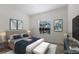 Bright bedroom with a bed between two tables below artwork beside a window at 7742 Ridgelake Cir, Bradenton, FL 34203