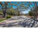 Grand entrance with paved driveway and security gates, surrounded by mature trees and landscaping at 7742 Ridgelake Cir, Bradenton, FL 34203