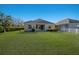 Well-maintained home exterior with a spacious green lawn, showcasing its backyard and serene surroundings at 7742 Ridgelake Cir, Bradenton, FL 34203