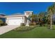 Inviting home exterior featuring lush landscaping, manicured lawn, and a two-car garage at 7742 Ridgelake Cir, Bradenton, FL 34203