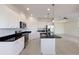 Modern kitchen with white cabinets, stainless appliances, and dark granite countertops at 7742 Ridgelake Cir, Bradenton, FL 34203