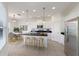 Modern kitchen with stainless steel appliances, island with seating, and bright recessed lighting at 7742 Ridgelake Cir, Bradenton, FL 34203