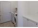 A clean laundry room features a new washer and dryer plus storage space at 7742 Ridgelake Cir, Bradenton, FL 34203