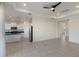 Bright open floor plan with kitchen and living area featuring tile flooring and modern appliances at 7742 Ridgelake Cir, Bradenton, FL 34203