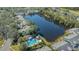 Aerial view of a community with a beautiful lake and a community pool surrounded by lush landscaping at 7742 Whitebridge Gln, University Park, FL 34201