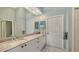 Spacious bathroom featuring double sinks with marble countertop and plenty of storage space at 7742 Whitebridge Gln, University Park, FL 34201