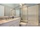 Bright bathroom with a marble countertop and a shower with sliding glass doors at 7742 Whitebridge Gln, University Park, FL 34201