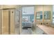Bathroom with a walk in shower and view through the hall to the main bedroom at 7742 Whitebridge Gln, University Park, FL 34201