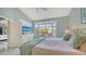 Bedroom with a large bay window that has water view, workspace, and a view to the lanai at 7742 Whitebridge Gln, University Park, FL 34201