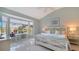 Light, bright bedroom with water view, a workspace, and a serene, coastal color palette at 7742 Whitebridge Gln, University Park, FL 34201