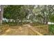 Outdoor deck area with wooden railings, lush landscaping, and mature trees providing shade at 7742 Whitebridge Gln, University Park, FL 34201