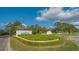 Community entrance featuring lush landscaping and a beautiful welcome sign, embodying a serene atmosphere at 7742 Whitebridge Gln, University Park, FL 34201
