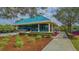 Exterior view of the tennis and fitness center with a path to the building at 7742 Whitebridge Gln, University Park, FL 34201