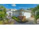Charming single Gathering home featuring manicured landscaping and an attached two-car garage at 7742 Whitebridge Gln, University Park, FL 34201