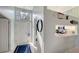 Light-filled entryway with an elegant chandelier and a view into the kitchen at 7742 Whitebridge Gln, University Park, FL 34201