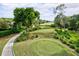 Picturesque golf course with manicured fairways, lush trees, and pristine greens creating a serene golfing experience at 7742 Whitebridge Gln, University Park, FL 34201