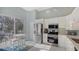 Modern kitchen featuring stainless steel appliances and a casual dining area by the windows at 7742 Whitebridge Gln, University Park, FL 34201