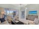 Bright living room featuring comfortable seating, neutral colors, and a view of the lake at 7742 Whitebridge Gln, University Park, FL 34201