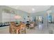 Open-concept living and dining area with large windows overlooking a serene water view at 7742 Whitebridge Gln, University Park, FL 34201