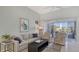 Inviting living room featuring comfortable seating and picturesque lake views at 7742 Whitebridge Gln, University Park, FL 34201