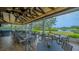 Outdoor patio with tables and chairs overlooking a lake and golf course at 7742 Whitebridge Gln, University Park, FL 34201