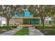 The restaurant's exterior features manicured landscaping and an entrance with orange doors and a blue roof at 7742 Whitebridge Gln, University Park, FL 34201