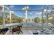 Picturesque sunroom features a table set and seating with lovely water views beyond at 7742 Whitebridge Gln, University Park, FL 34201