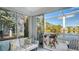 Relaxing sunroom with comfortable seating and beautiful views of the surrounding lake at 7742 Whitebridge Gln, University Park, FL 34201