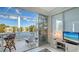 The sunroom offers a serene spot with seating and scenic views of the lake at 7742 Whitebridge Gln, University Park, FL 34201