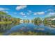 Beautiful view of the calm community lake with natural scenery and multiple townhouses at 7742 Whitebridge Gln, University Park, FL 34201