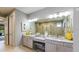Bathroom featuring double vanity, granite counters, and large mirror at 9128 Radiant Cir, Sarasota, FL 34241
