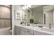 Modern bathroom featuring double sinks, neutral wall colors, and a bathtub shower at 9128 Radiant Cir, Sarasota, FL 34241