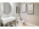 Stylish powder room featuring a modern sink, round mirror, and contemporary decor at 9128 Radiant Cir, Sarasota, FL 34241