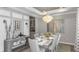 Elegant dining room featuring a modern chandelier, large table with seating, and stylish decor at 9128 Radiant Cir, Sarasota, FL 34241
