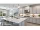 Modern kitchen with stainless steel appliances, pendant lights, and a large island with seating at 9128 Radiant Cir, Sarasota, FL 34241
