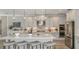 Gourmet kitchen with stainless steel appliances, kitchen island, and stylish pendant lighting at 9128 Radiant Cir, Sarasota, FL 34241