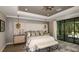 Beautifully decorated main bedroom with king bed and sliding glass doors at 9128 Radiant Cir, Sarasota, FL 34241