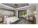 Luxurious main bedroom with a king bed, stylish rug, and sliding glass doors to an outdoor seating area at 9128 Radiant Cir, Sarasota, FL 34241