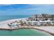 Stunning aerial view of beachfront condos, showcasing the pool, white sands, and turquoise waters at 100 Sands Point Rd # 225, Longboat Key, FL 34228