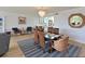 Open concept living and dining area with wicker chairs and modern decor at 100 Sands Point Rd # 225, Longboat Key, FL 34228