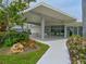 Community clubhouse featuring exterior seating, garden views, and sidewalk at 100 Sands Point Rd # 225, Longboat Key, FL 34228