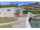 A building near a dock with colorful kayaks, offering convenient access to water activities at 100 Sands Point Rd # 225, Longboat Key, FL 34228
