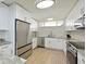 Clean and modern kitchen featuring stainless steel appliances and white cabinetry at 100 Sands Point Rd # 225, Longboat Key, FL 34228