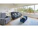 Cozy living room with ample seating, area rug, and scenic view at 100 Sands Point Rd # 225, Longboat Key, FL 34228